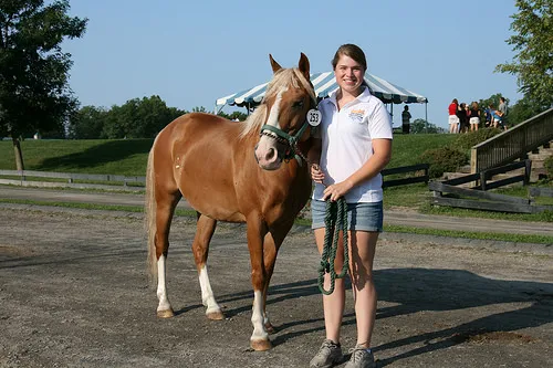 Dr. Geick's daughter poses for a picture with her show and dressage horse