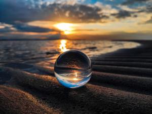 Crystal ball hovering in front of sunset